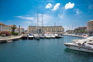 a group of boats docked in a harbor with buildings at San Paolo Hospital 2mins - HiperWifi - SmartTV - AC in Savona