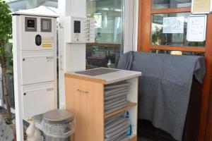 an office with a desk with a drawer and a machine at Hotel-Gasthof Zur Rose in Weißenhorn