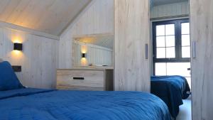 Ένα ή περισσότερα κρεβάτια σε δωμάτιο στο WoodNess Guest House Spacious 3BR Sauna BBQ area