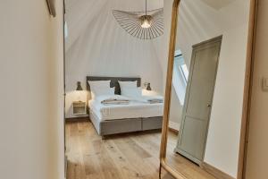 Postel nebo postele na pokoji v ubytování Hôtel de Ville