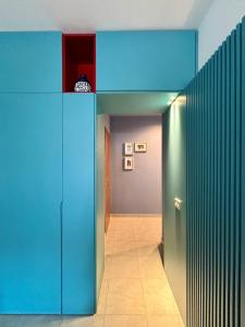 a hallway with blue walls and a blue door at Studiò in Termoli +9 photos