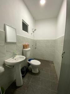 a bathroom with a toilet and a sink at Awienna House in Kota Kinabalu