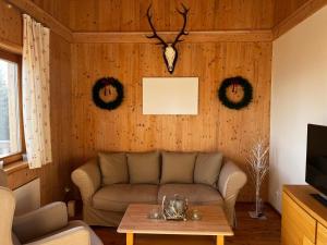 a living room with a couch and a table at Almchalet Villa Diana in Klippitztorl