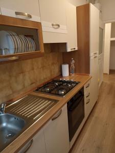 a kitchen with a stove and a sink at Maria in Palmanova