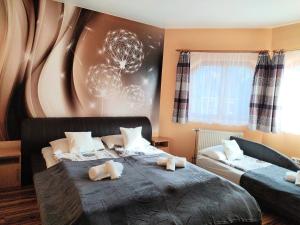 a bedroom with two beds with teddy bears on them at Norbert Vendégház in Balatonszárszó