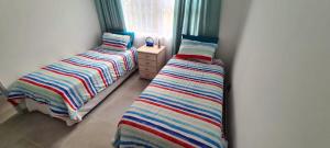 two beds sitting next to each other in a bedroom at Westbrook Blue Largo 33 in Westbrook