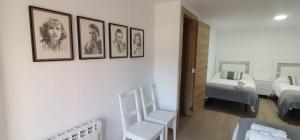 a room with four pictures on the wall and a bedroom at Casa Dolores in Villahermosa del Río +11 photos