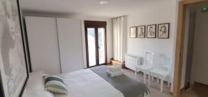 a bedroom with a bed and a desk and a window at Casa Dolores in Villahermosa del Río +23 photos