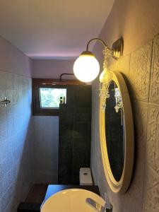 a bathroom with a sink and a light and a mirror at Luxury suites in Villa Anasia, Olympia in Skotina +16 photos