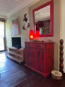 a room with a red dresser with a mirror on it at Luxury suites in Villa Anasia, Olympia in Skotina