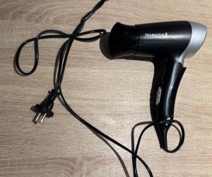 a black blow dryer sitting on top of a table at Open Room Comfort in Cape Town