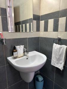 a bathroom with a white sink and a mirror at Spacious studio Ruaka in Ruaka