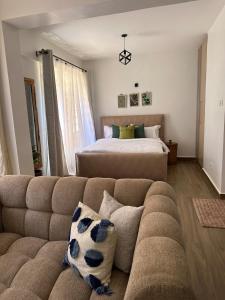 a living room with a couch and a bed at Spacious studio Ruaka in Ruaka