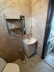 a bathroom with a toilet and a sink at Вили Панорама 2 in Chernomorets