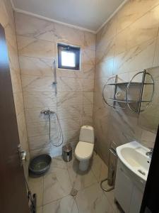 a bathroom with a shower and a toilet and a sink at Вили Панорама 2 in Chernomorets +5 photos