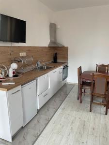 a kitchen with a sink and a table with a tableablish at Вили Панорама 2 in Chernomorets