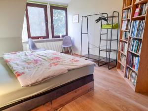 une chambre avec un lit et une étagère dans l'établissement Ferienwohnungen am Waldrand, à Ahrenshagen