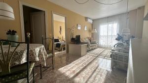 a bedroom with a bed and a living room at Apartament GECO - near the beach in Lo Pagan in San Pedro del Pinatar
