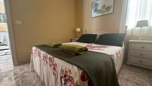 a bedroom with a bed with two green pillows on it at Apartament GECO - near the beach in Lo Pagan in San Pedro del Pinatar +48 photos