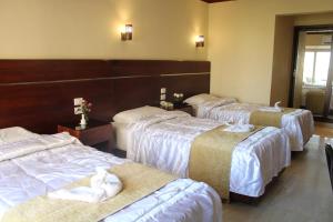 a group of four beds in a hotel room at Pharaohs Hotel in Cairo +71 photos