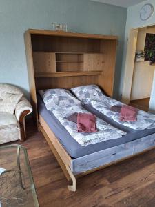 a bedroom with a bed with a wooden headboard at FeWo Capreolus in Winterberg