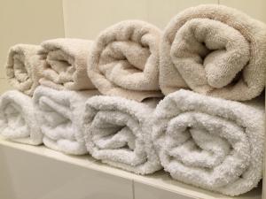 a pile of towels sitting on a shelf at Beautiful Apartments in Prague in Prague