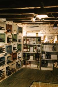 a room filled with lots of bottles of wine at Vinalia - Conacul din Ceptura in Ceptura de Jos