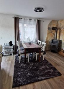 a dining room with a table and a fireplace at Haus am See in Lindow +8 photos