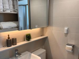 a bathroom with a sink and a mirror and a toilet at View-HongDae in Seoul