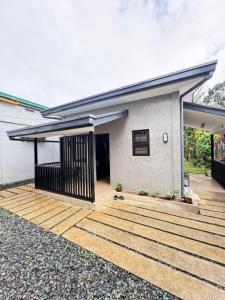 a house with a wooden deck in front of it at Pio Transient House in Tanay