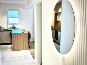 a mirror on the wall of a kitchen with a table at 4FriendsBrasov K34 in Braşov