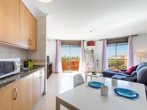 a kitchen and living room with a couch and a table at Sea breeze Sotavento III in La Tejita