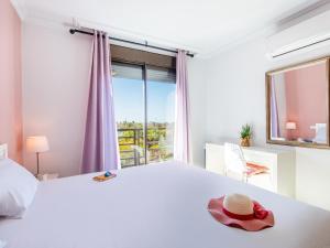 a bedroom with a large bed with a hat on it at Sea breeze Sotavento III in La Tejita +21 photos