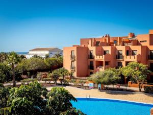 a view of a resort with a swimming pool at Sea breeze Sotavento III in La Tejita