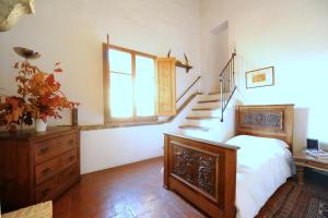 a bedroom with a bed and a window and stairs at Acacia Firenze - Primula in Florence