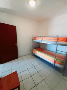 a room with two bunk beds and a chair at house on the sea 3 in Ischia