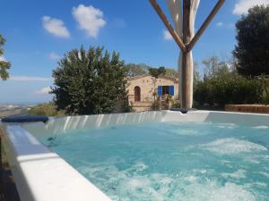 a swimming pool with a view of a house at mansio maritima in Moresco