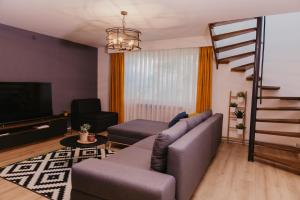 a living room with a couch and a television at Kuća za odmor Maja in Ðakovo