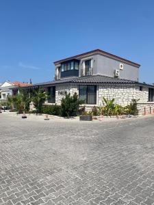 a building on a street in front of a building at Chloe hotel Alacati in Alacati