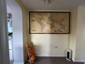 a map of the world hanging on a wall at Quest Fulfiller - Near General Hospital, Free Parking & Garden in Southampton