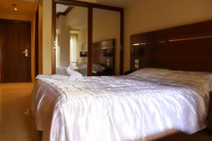 a bedroom with a large bed with a stuffed animal on it at Pharaohs Hotel in Cairo