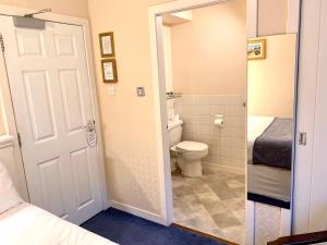 a bathroom with a toilet and a bed and a door at Woodlea in Perth +38 photos