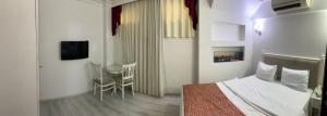 a hotel room with a bed and a table and chairs at Nacre Residence in Istanbul