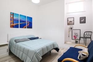 a bedroom with a bed with a blue comforter at Casa JOY in Las Palmas de Gran Canaria