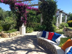 a white couch with colorful pillows sitting on a patio at Hotel Al Mulino in Anacapri