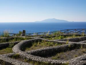 a group of stone steps on a hill overlooking the ocean at Hotel Al Mulino in Anacapri