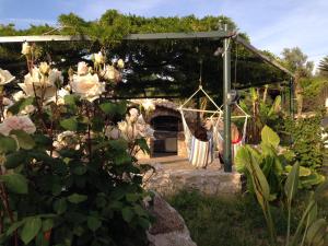 a garden with a pergola with white flowers at Hotel Al Mulino in Anacapri