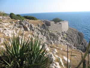 a castle on the side of a cliff near the ocean at Hotel Al Mulino in Anacapri