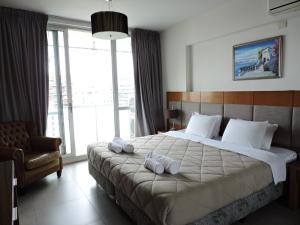 a bedroom with a large bed with a large window at Rivadavia Apartment in Buenos Aires +160 photos