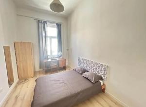 a bedroom with a large bed in a room at Leo Heart Rooms in Budapest